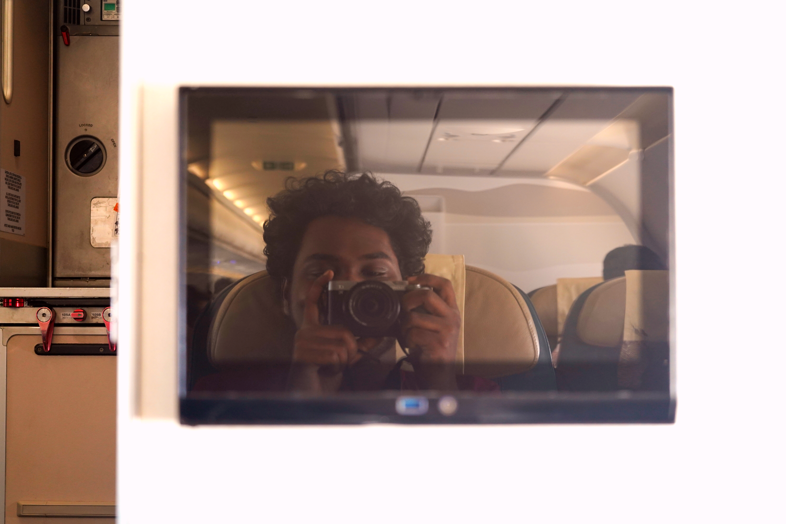 Rohit with camera on a plane