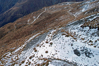 Downward view of snow-covered Heather Jock track with visible paths leading to Mt McIntosh.