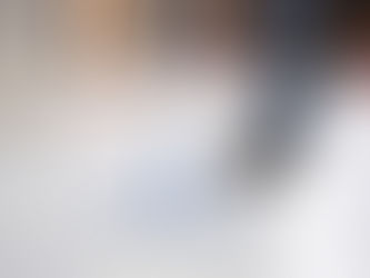 Person mopping a clean floor in a workshop.