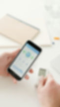 a patient using a medical device with the results displayed on their smart phone.