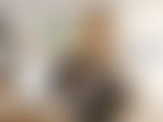 Modern kitchen renovation in progress with quartz island, white cabinets, and contractor reviewing cost plans