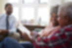 Insurance agent meets with a couple and reviews their current coverage.