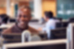 Happy insurance staff member calls to schedule appointments to review policies.
