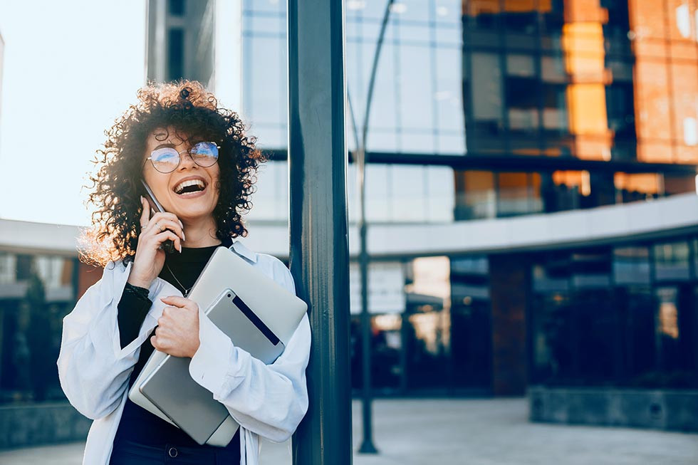 Young woman answers the phone call from her insurance company.