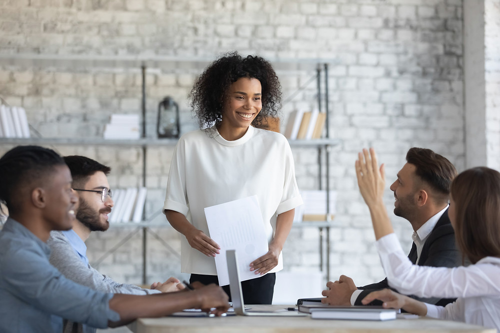 Insurance agency owner trains her staff members in a group setting.