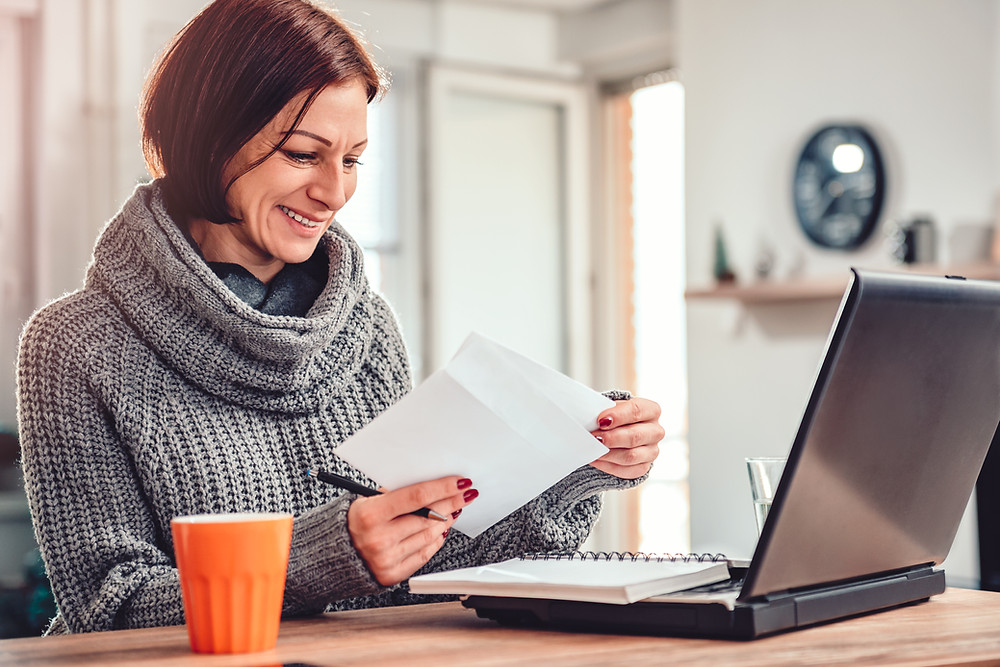 Woman receives mail from her insurance agent.