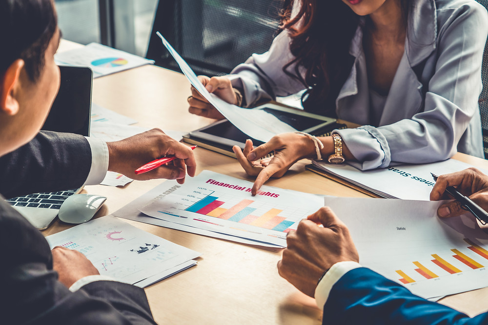 Insurance team meets to plan how to target most profitable customers.
