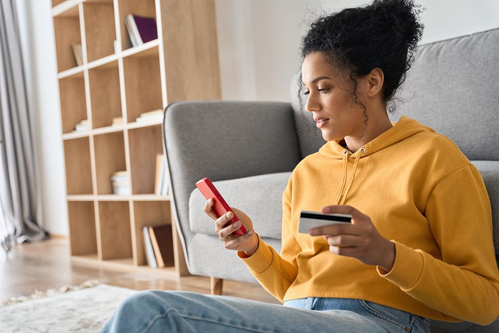 Millennial woman searches for local insurance agencies on her smart phone.