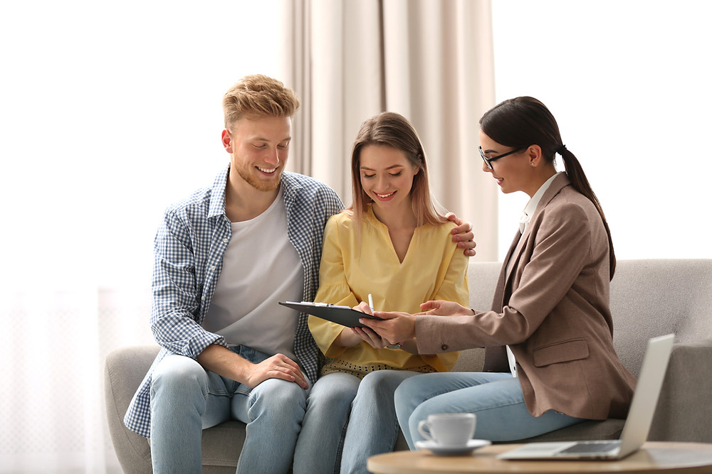 insurance agent meets with young couple