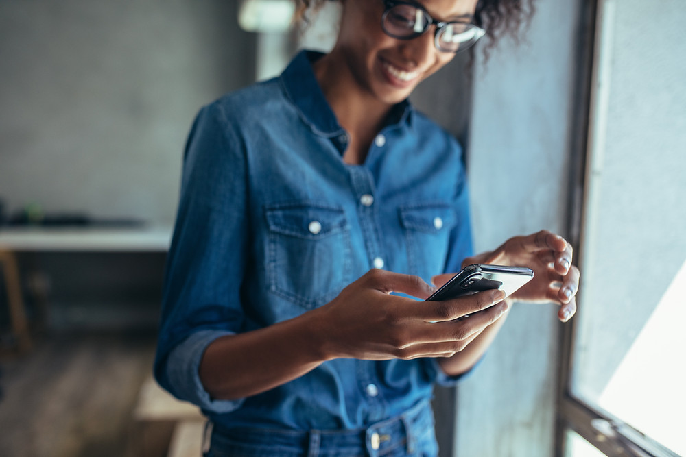 Woman looks at her smart phone.