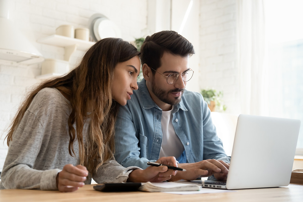 Young couple browses the web for insurance options