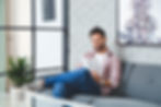 Insurance client sits in lobby and reads information from his agent about car insurance.