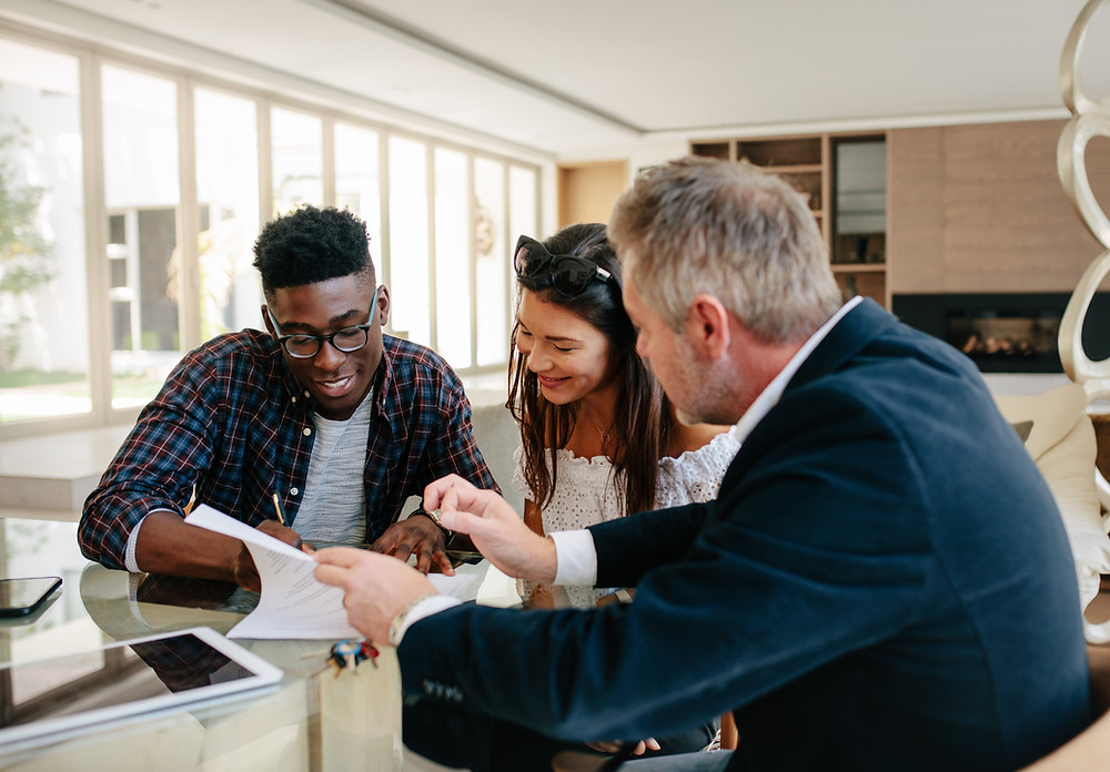 Insurance agent meets with clients to review and add coverage.
