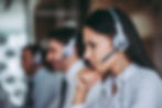 Call center representative listening intently to customer over the phone.