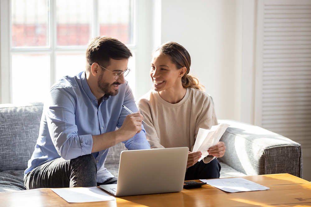 Young couple discusses when they can schedule their insurance review appointment with their agent.