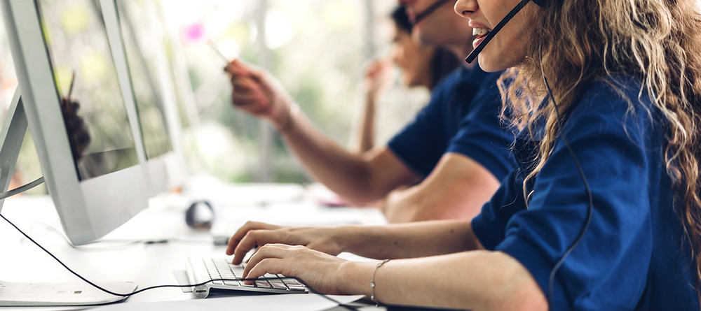 Call center agents use software to track information while setting insurance review appointments