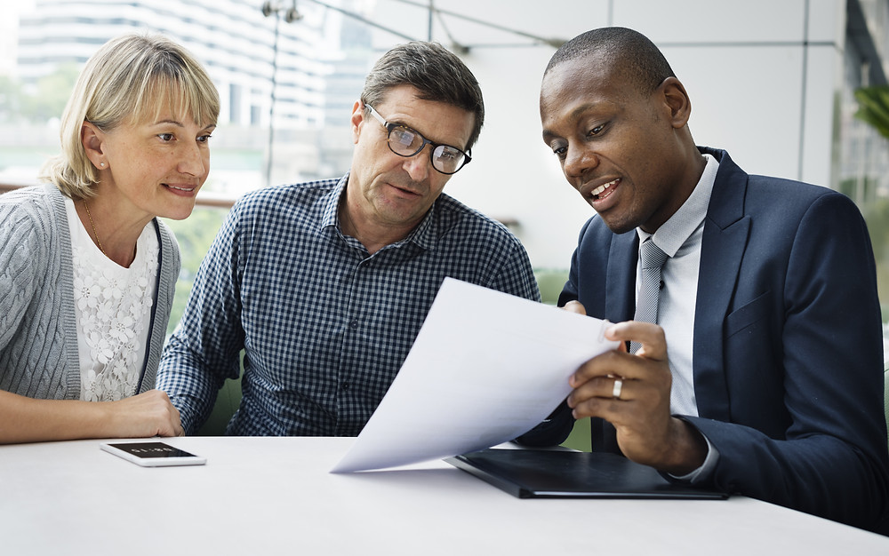 Insurance agent meets with customers to update their policies.