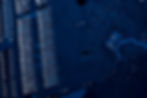Close-up of a blue computer motherboard showing intricate circuits and microchip connections, symbolizing technology, digital