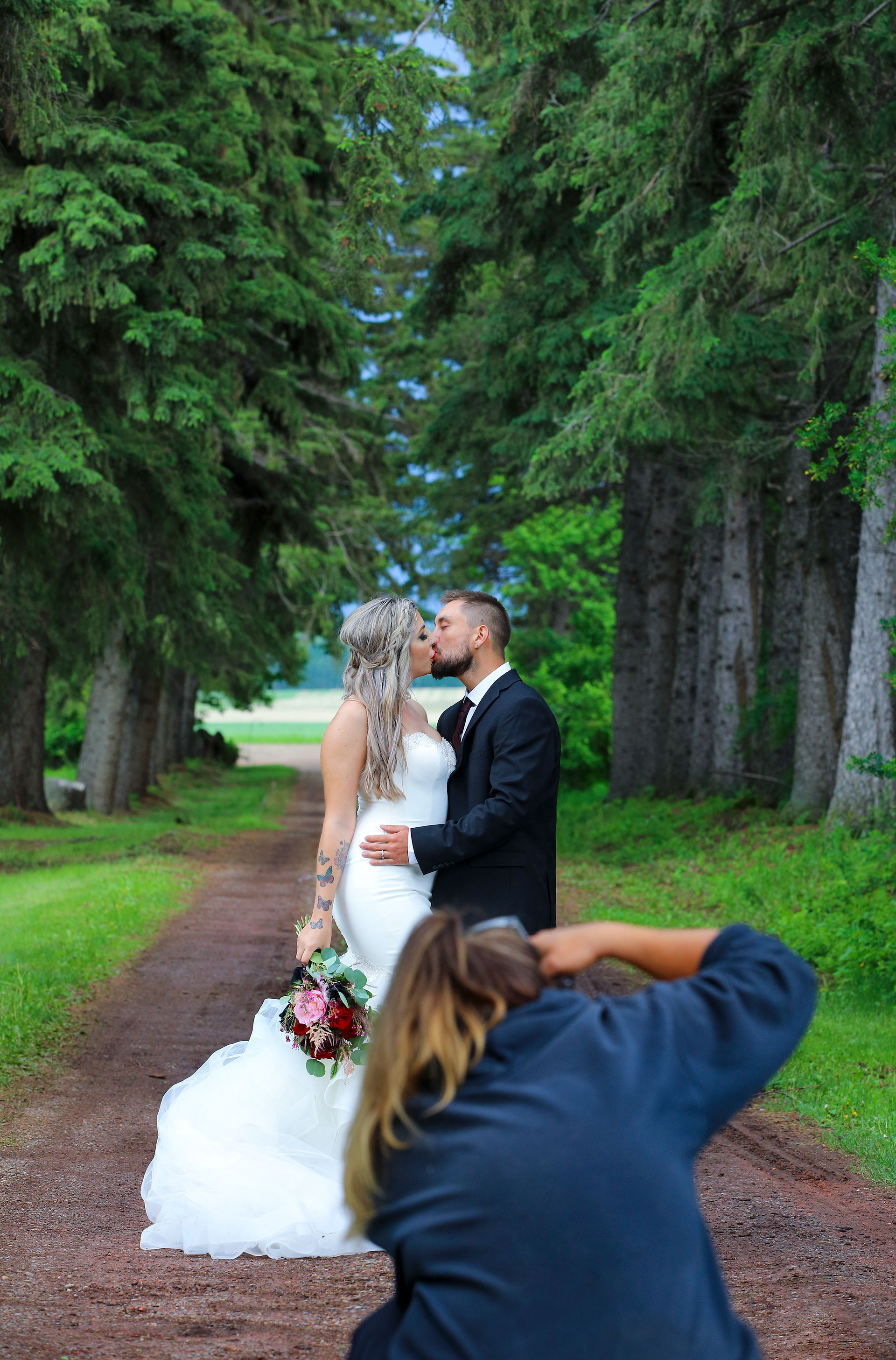 A photographer capturing a wedding portrait moment.