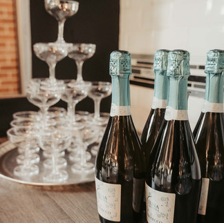 Sparkling champagne bottles and elegant coupe tower at a celebration.