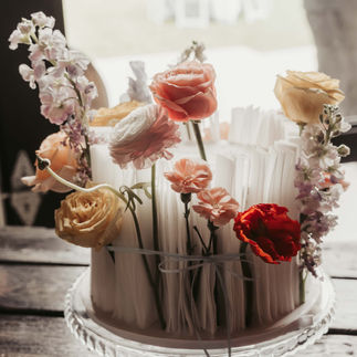 Elegant floral arrangement with pink, orange, yellow, and red blossoms.