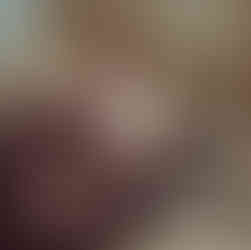 A man leaning over a barrel