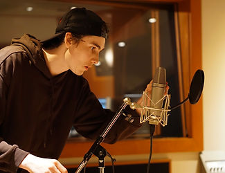 Stuart placing a microphone for recording in a recording studio