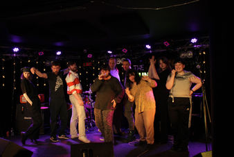 Photo of StoryTree host Georgia Francis with March Poetry Slam competitors. 