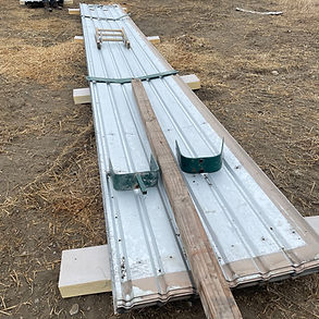 Reclaimed 24-gauge ribbed metal roofing panels for agricultural and rural construction in Southern Alberta