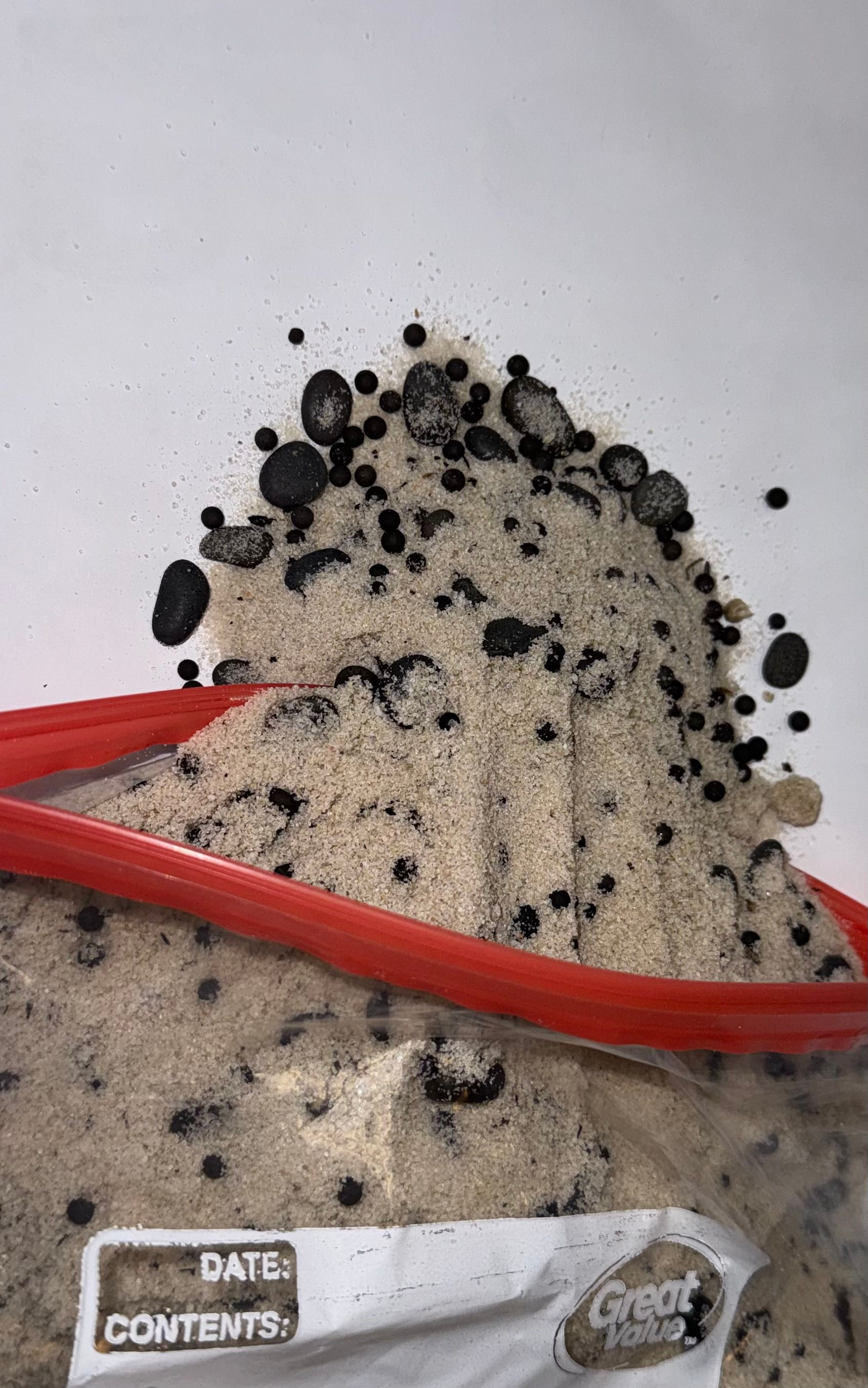 White sand with black pebbles
