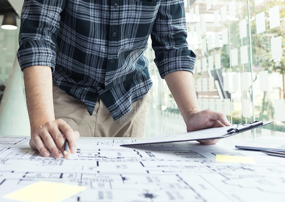 vecteezy_interior-designer-or-architect-reviewing-blueprints-and_6686012.jpg