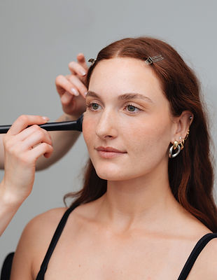 a model getting blush applied