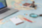 Assorted mapping related items laid on map of the world