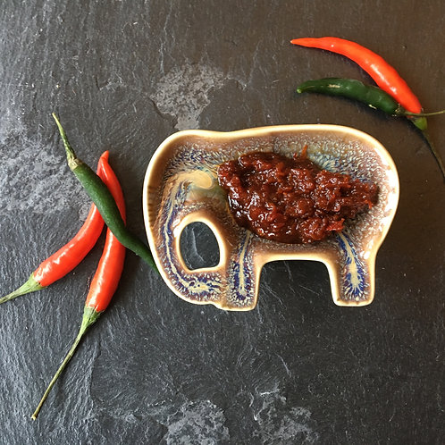 Elephant Bowl with Chillies on Black Background