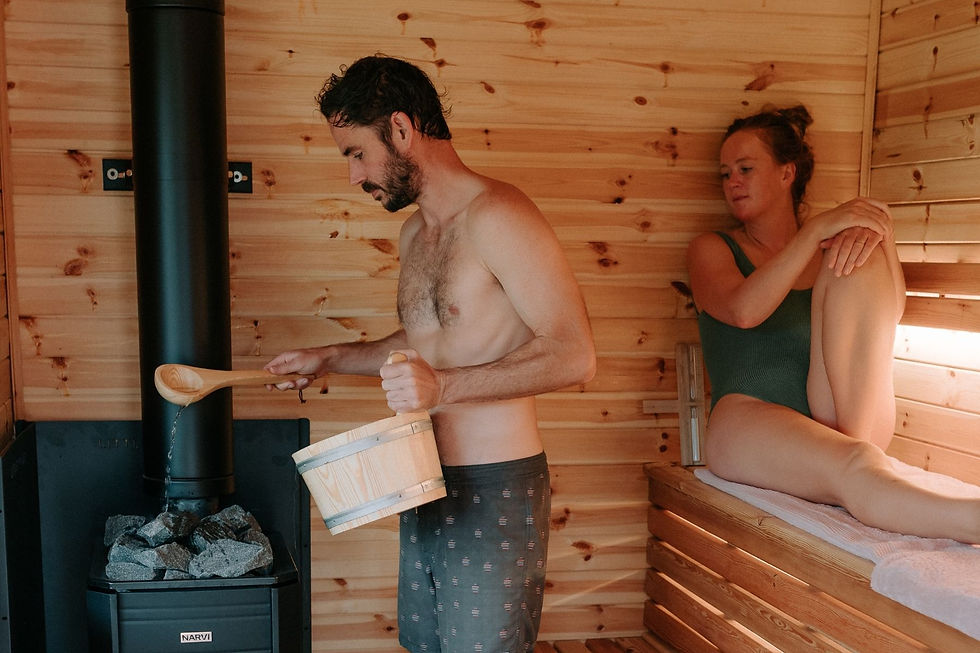 Couple enjoying the sauna at HARTA retreat North Devon.