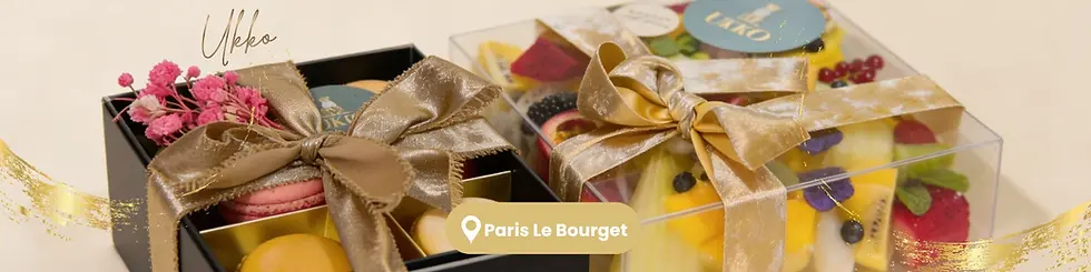 Gift boxes with golden ribbons, one with macarons and flowers, another with fruits. Text reads Ukko, Paris Le Bourget on a beige background.