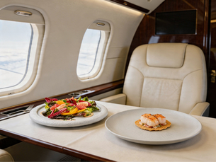 Private jet table with two meals placed on top (king crab salad, turbot fillet)