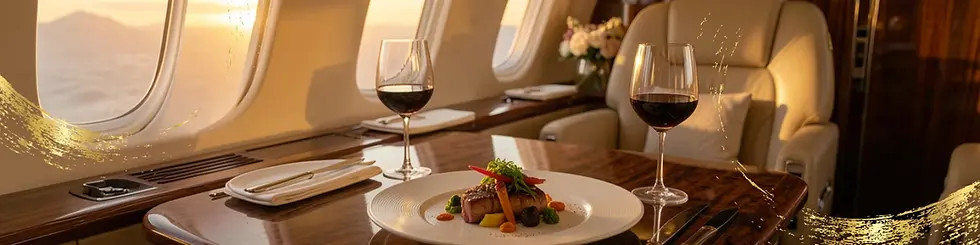 Elegant private jet dining with a gourmet meal and two glasses of red wine on a polished wooden table. Sunset view through windows.