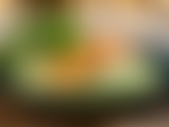 Salmon fillet on green emulsionated sauce, with lettuce and cucumber on the side