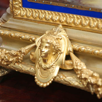 an antique French Victorian bronze gilt ormolu mantel clock with blue porcelain panels and domes sides hand painted with musical instruments and butterflies. The movement strikes on a bell by Japy Freres