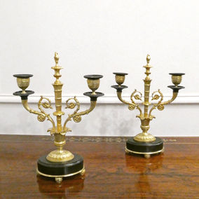 A French mid 19th century bronze and gilt bronze antique clock set with mantel clock and candelabra garnitures. The clock has gilt cranes with a cherub in a chariot by Japy Freres