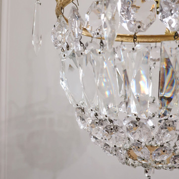 an antique Italian Art Deco bag chandelier with graduating faceted cut crystal glass finished with floral shaped glass motif underneath