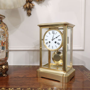French 19th century brass gorge case antique mantel clock with four bevelled glass panels and eight day movement which strikes on a gong.