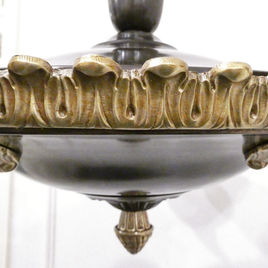 An Art Deco period bronze chandelier in the Empire Style with gilt bronze arms terminating to alabaster shades