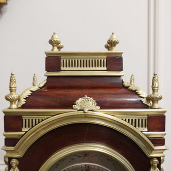 an antique French mahogany Victorian mantel clock in the Louis XIV style with ormolu mounts and silvered dial. The movement is a twin fusee and strikes the hours on a gong,