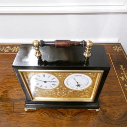 Edwardian timepiece clock with aneroid barometer within an ebonised case