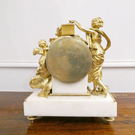 French Louis XVI style antique mantel clock with gilt bronze female and cherub figures with doves, on a white marble base with movement striking on a bell