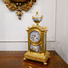 French Louis XVI style gilt bronze antique mantel clock with hand painted porcelain panels. The movement strikes on a bell by Japy Freres