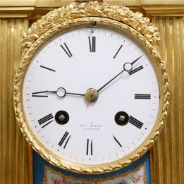 French Louis XVI style gilt bronze mantel clock with inset porcelain panels and movement by Henry Marc of Paris