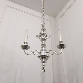 an antique silver plated three arm chandelier with shaped curved arms with leaf bobeche cups and term figures to the top with gadroon moulding